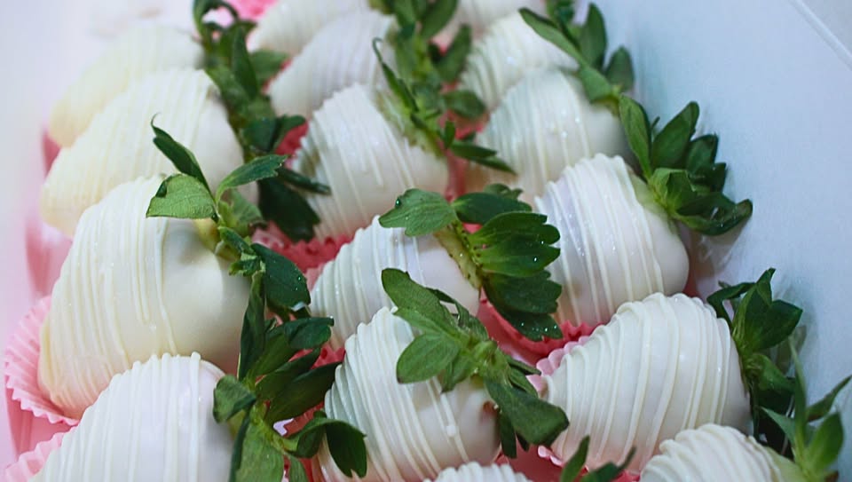 White chocolate covered strawberries with pink drizzle